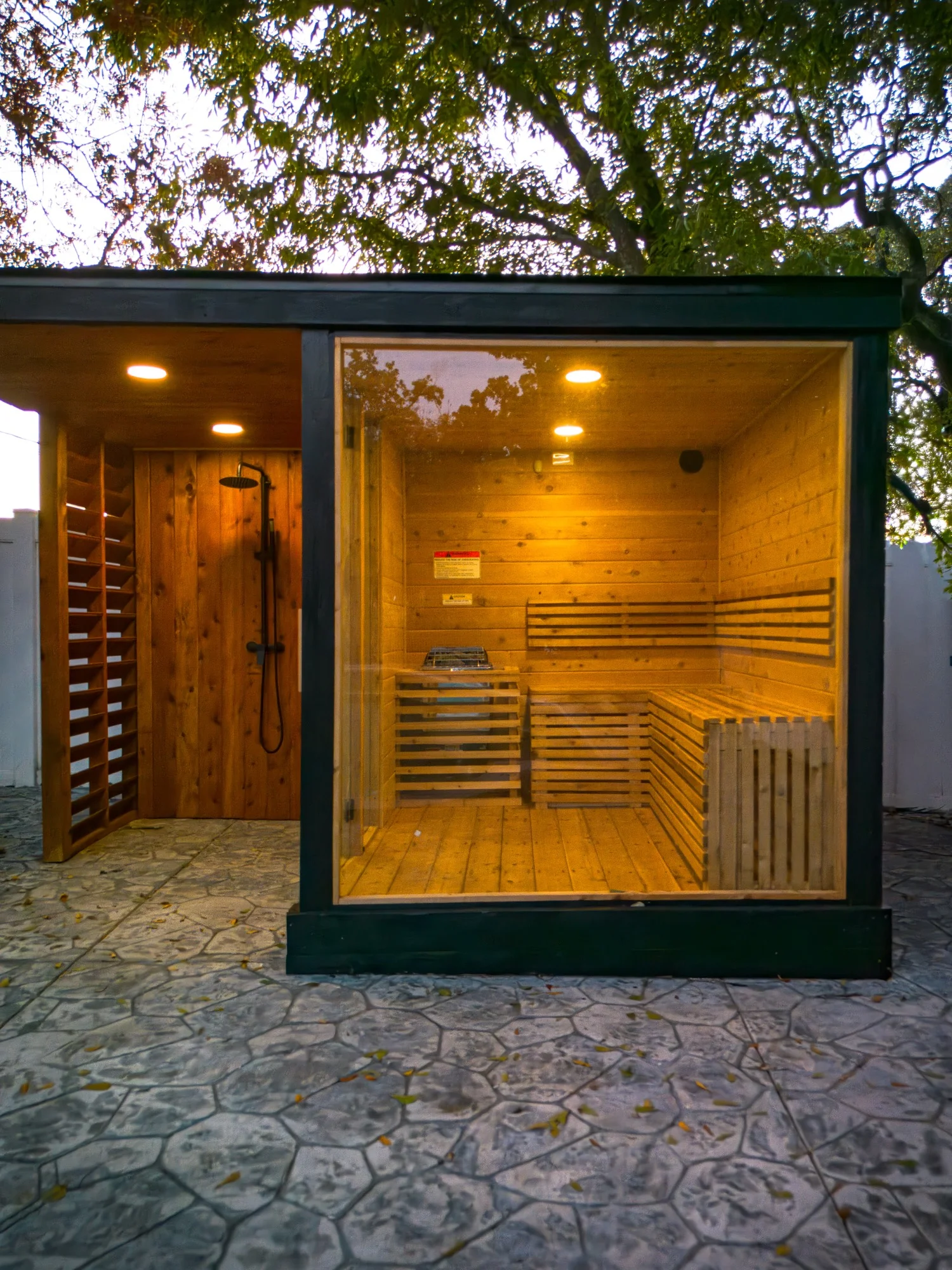 Front view of outdoor sauna with full glass wall