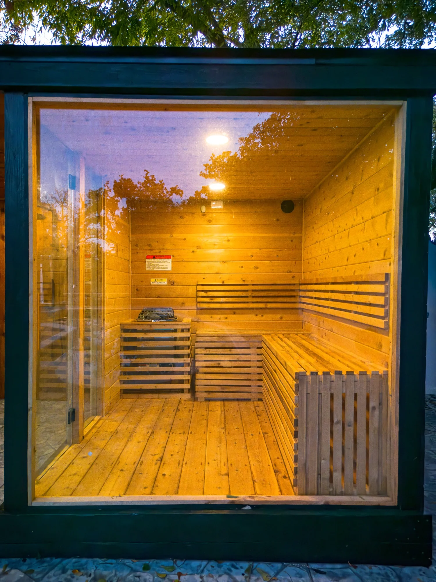 View through glass wall into cedar sauna interior