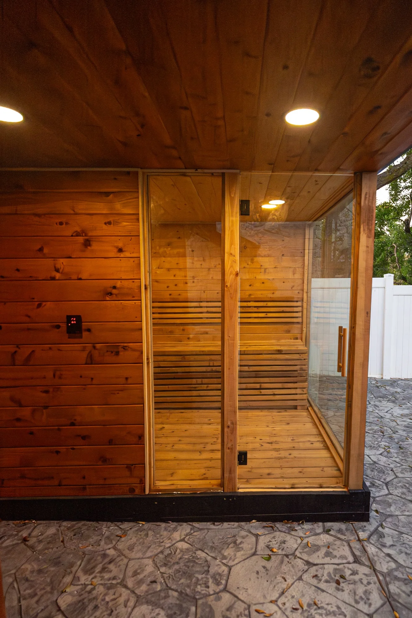 Glass door entrance to outdoor cedar sauna