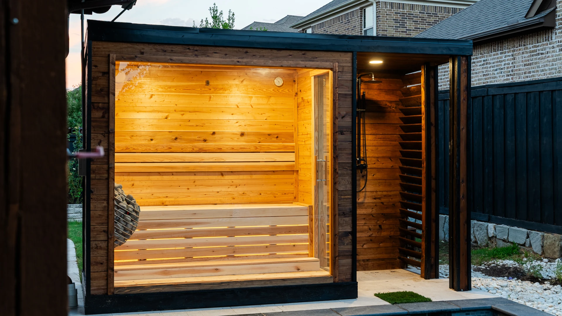 Sauna glass front with outdoor shower and louvered screen beside the pool